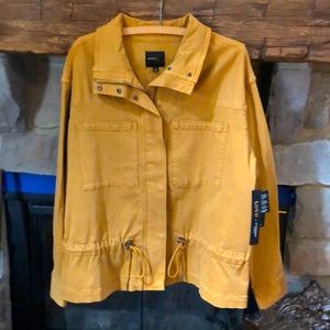 Liverpool zipper and snap front jacket with adjustable tie.